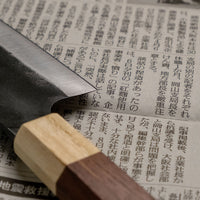 This Santoku Funayuki SUJ-2 blade is fitted with an octagonal rosewood handle with a cedar ferrule. Great for cutting smaller pieces of meat and filleting fish.  The blade is forged from SUJ-2 steel, which offers incredible capacities, hardness is 63-64 HRC, and at the same time the knife is very easy to resharpen. 