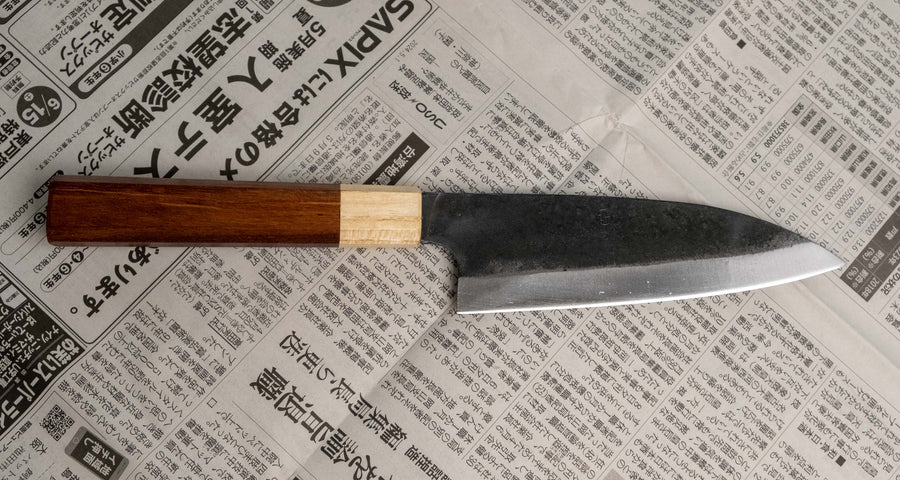 This Santoku Funayuki SUJ-2 blade is fitted with an octagonal rosewood handle with a cedar ferrule. Great for cutting smaller pieces of meat and filleting fish.  The blade is forged from SUJ-2 steel, which offers incredible capacities, hardness is 63-64 HRC, and at the same time the knife is very easy to resharpen. 