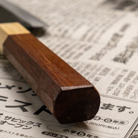 This Santoku Funayuki SUJ-2 blade is fitted with an octagonal rosewood handle with a cedar ferrule. Great for cutting smaller pieces of meat and filleting fish.  The blade is forged from SUJ-2 steel, which offers incredible capacities, hardness is 63-64 HRC, and at the same time the knife is very easy to resharpen. 