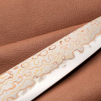 Hayabusa Petty Aogami #2 Rainbow Damascus 150mm is a versatile Japanese kitchen knife ideal for preparing meat, fish, and vegetables. Its blade, made of Aogami #2 steel, is thin and precise. It excels in sharpness, edge retention, and ease of maintenance, but above all looks - with the unique rainbow damascus pattern!