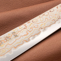 Hayabusa Petty Aogami #2 Rainbow Damascus 150mm is a versatile Japanese kitchen knife ideal for preparing meat, fish, and vegetables. Its blade, made of Aogami #2 steel, is thin and precise. It excels in sharpness, edge retention, and ease of maintenance, but above all looks - with the unique rainbow damascus pattern!