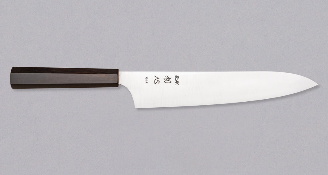 Full view of Hayabusa Gyuto Aogami Super Ebony 210 mm knife with ergonomic ebony wood handle, designed for comfort and control.
