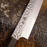 Close-up view of the Hayabusa Petty VG-10 Tsuchime 150 mm blade, showcasing its hammered tsuchime finish and precision craftsmanship.