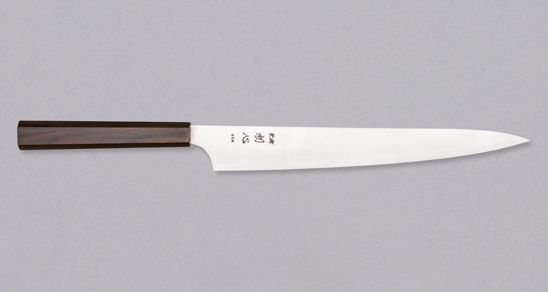 Hayabusa Sujihiki Aogami Super Ebony 270mm knife with an elegant ebony handle, showcasing its long, sharp blade ideal for precise slicing tasks