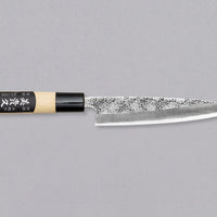 Petty Shirogami #2 Hammered 150mm by Ikeuchi Hamono is a short, double-bevel petty knife, intended for all sorts of smaller kitchen tasks, like mincing herbs, cleaning and preparing vegetables, peeling potatoes, you name it! This Petty is made of White steel #2 (Shirogami) and has a tsuchime nashiji blade finish.