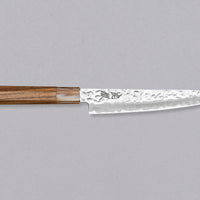 The Kotetsu VG-10 Damascus Petty 150 mm is a small Janapese knife with visible hammer prints, a damascus pattern and a classic Japanese (wa-style) teak handle. VG-10 stainless steel ensures rust resistance, durability, and wear resistance. Because it is low-maintenance, it is suitable as a first Japanese kitchen knife.
