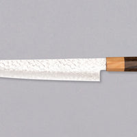 The Kotetsu Sujihiki VG-10 Damascus 240mm (9.5") is a long and narrow Japanese slicer with visible hammer prints, a damascus pattern, and a classic Japanese (wa-style) pakka wood handle. It will impress anyone who appreciates aesthetically designed kitchen utensils.