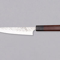 Kurosaki Petty Fujin is a uniquely looking blade from the talented Yu Kurosaki. Petty is a small kitchen knife perfect for all those delicate tasks where a larger knife is deemed unwieldy. Core from SG2 powder steel is enveloped in softer steel with a striking tsuchime pattern. Fitted with an octagonal rosewood handle.