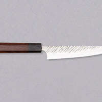 Kurosaki Petty Fujin is a uniquely looking blade from the talented Yu Kurosaki. Petty is a small kitchen knife perfect for all those delicate tasks where a larger knife is deemed unwieldy. Core from SG2 powder steel is enveloped in softer steel with a striking tsuchime pattern. Fitted with an octagonal rosewood handle.