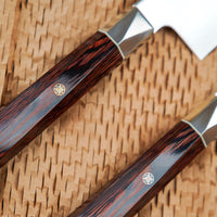 The Mcusta Zanmai Supreme Twisted Knife Set offers great versatility, featuring two multi-purpose knives that cover most cutting tasks in the kitchen. The minimalistic, highly polished blades are made of low-maintenance stainless VG-10 steel and are designed to put the focus on the uniquely shaped twisted handle.