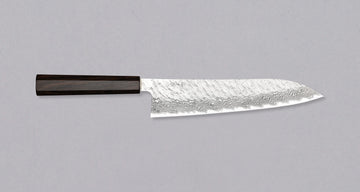 Nigara Gyuto VG-10 Damascus Tsuchime 240mm (9.4") is a multi-purpose Japanese kitchen knife, suitable for preparing meat, fish, and vegetables. VG-10 stainless steel ensures a fine sharpness with little to no maintenance. As such, the knife is also suitable as a first Japanese knife or gift. Fitted with an ebony handle.
