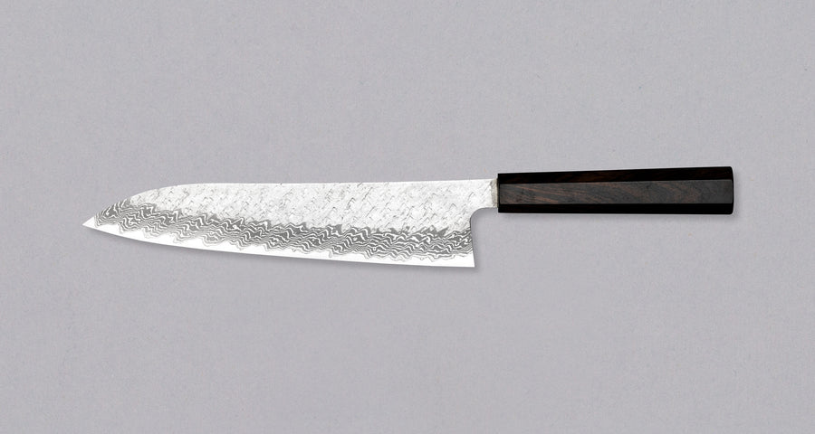 Nigara Gyuto VG-10 Damascus Tsuchime 240mm (9.4") is a multi-purpose Japanese kitchen knife, suitable for preparing meat, fish, and vegetables. VG-10 stainless steel ensures a fine sharpness with little to no maintenance. As such, the knife is also suitable as a first Japanese knife or gift. Fitted with an ebony handle.