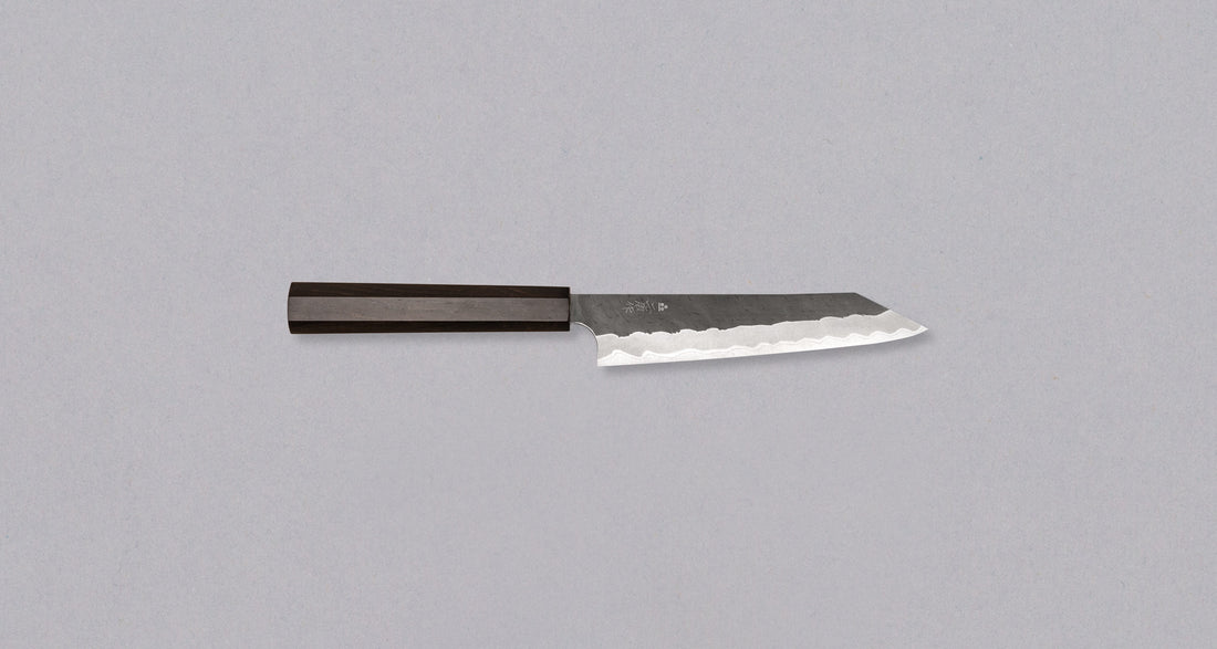 Right side view of the Nigara Kiri-Petty Aogami Super Migaki Tsuchime 150 mm, highlighting the elegant design and functionality of this Japanese knife. The Nigara Hamono logo and kanji are visible, adding a unique touch to the blade.