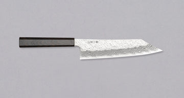 Nigara Kiritsuke Gyuto VG-10 Damascus Tsuchime 210mm (8.2") is a multi-purpose Japanese kitchen knife, suitable for preparing meat, fish, and vegetables. VG-10 stainless steel ensures a fine sharpness with little to no maintenance. As such, the knife is also suitable as a first Japanese knife or gift. Fitted with an ebony handle.