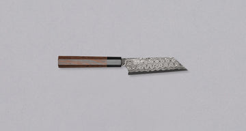 Nigara Kiritsuke Petty SG2 Damascus 120mm is a Japanese kitchen knife suitable for smaller cutting tasks. It's adorned with a raindrop damascus pattern and fitted with a wenge wood handle. Its SG2 powder steel core ensures long-lasting sharpness with little to no maintenance, as the steel resists corrosion very well.