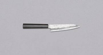 Nigara Petty VG-10 Damascus Tsuchime 150mm (5.9") is a small multi-purpose Japanese kitchen knife, suitable for in-hand and smaller cutting tasks. VG-10 stainless steel ensures a sharpness with little to no maintenance. As such, the knife is also suitable as a first Japanese knife or gift. Fitted with an ebony handle.