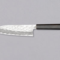 Nigara Santoku VG-10 Damascus Tsuchime is a multi-purpose Japanese kitchen knife, suitable for preparing meat, fish, and vegetables. Its VG-10 stainless steel core ensures a fine sharpness with little to no maintenance. As such, the knife is also suitable as a first Japanese knife or gift. Fitted with ebony handle.