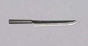 Nigara Sakimaru Sujihiki SG2 Kurouchi Tsuchime 270mm (10.6") [Ebony] is a traditional Japanese knife used for preparing meat and raw fish. It slices protein in one pulling motion, creating smooth, shiny cuts. Its SG2 powder steel core ensures long-lasting sharpness with little to no maintenance. A beast of a knife!