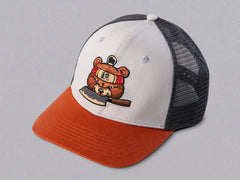 SharpEdge exclusive merch: SharpEdge x Vincent Trinidad Trucker Hat Exclusive SharpEdge design of a brown sumo-fighting bear, armed with our ZDP-189 Bunka Black Japanese knife in collaboration with artist Vincent Trinidad. The bottom of the sturdy visor features the SharpEdge logo within a Japanese rising sun.