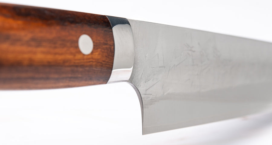 Handle of knife. Saji Gyuto SRS13 Tsuchime 240mm (9.4") is a multi-purpose Japanese kitchen knife, suitable for preparing meat, fish, and vegetables. It’s a truly out-of-this-world piece of knifemaking. Its heart was forged out of SRS13, a high-speed powder steel, renowned for its high hardness and excellent corrosion resistance.