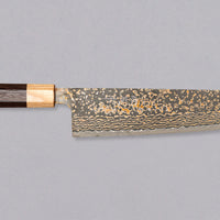 The Saji Gyuto VG-10 Gold RWO 240mm is a high-quality, multi-purpose Japanese knife crafted by Takeshi Saji of Takefu Knife Village. It has a special lamination process where brass is added to the outer layers to achieve a gold-colored damascus pattern. It's made from stainless VG-10 steel and has a rosewood wa handle.