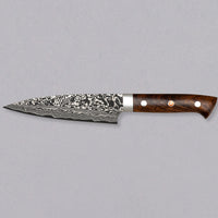 Saji Petty R2 Ironwood 130mm is not just a looker. The core is made of powder R2/SG2 steel, tempered to around 63 HRC, and clad into layers of rust-resistant stainless steel which creates a unique damascus pattern. The knife is stored in a traditional Japanese wooden box with burned Saji trademark kanji on top.