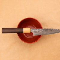 The Saji Petty VG-10 Gold RWO 135 mm is a small Japanese kitchen knife suitable for preparing meat, fish and vegetables. However, it would be an injustice to call it just a kitchen knife, as it is a remarkable example of blacksmith's craftsmanship - from its unique design to its very specific features.