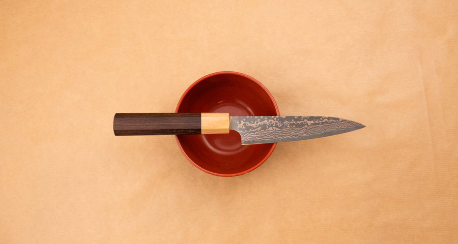 The Saji Petty VG-10 Gold RWO 135 mm is a small Japanese kitchen knife suitable for preparing meat, fish and vegetables. However, it would be an injustice to call it just a kitchen knife, as it is a remarkable example of blacksmith's craftsmanship - from its unique design to its very specific features.