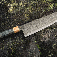 The Senzo Dawn Limited Edition Gyuto SG2 200mm (7.9") is a multi-purpose Japanese knife, hand-made in the Japanese smithy Suncraft. It's a stunning collector's item. The knife is fitted with a traditional Japanese octagonal handle topped with a special ferrule made from the wood of a 300-year-old holy oak tree.