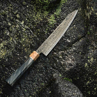 The Senzo Dawn Limited Edition Petty SG2 150mm (5.9") is a small multi-purpose Japanese knife, hand-made in the Japanese smithy Suncraft. It's a stunning collector's item. The knife is fitted with a traditional Japanese octagonal handle topped with a special ferrule made from the wood of a 300-year-old holy oak tree.