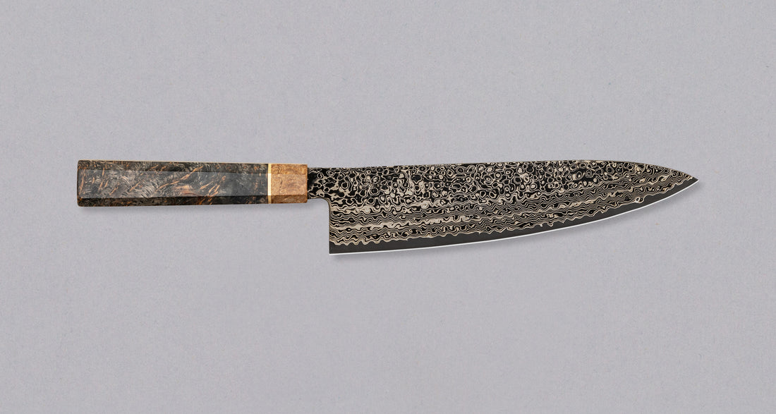 The Senzo Dawn Limited Edition Gyuto SG2 200mm (7.9") is a multi-purpose Japanese knife, hand-made in the Japanese smithy Suncraft. It's a stunning collector's item. The knife is fitted with a traditional Japanese octagonal handle topped with a special ferrule made from the wood of a 300-year-old holy oak tree.