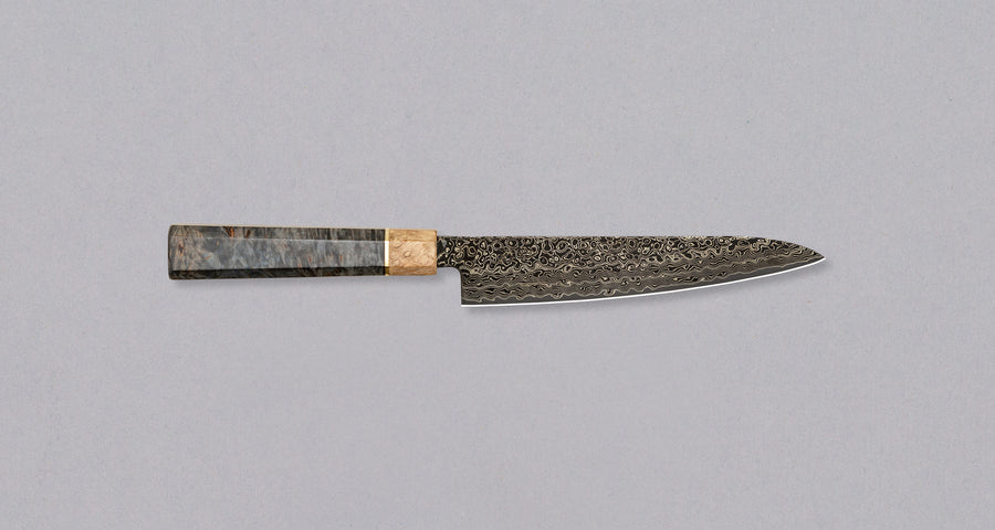 The Senzo Dawn Limited Edition Petty SG2 150mm (5.9") is a small multi-purpose Japanese knife, hand-made in the Japanese smithy Suncraft. It's a stunning collector's item. The knife is fitted with a traditional Japanese octagonal handle topped with a special ferrule made from the wood of a 300-year-old holy oak tree.