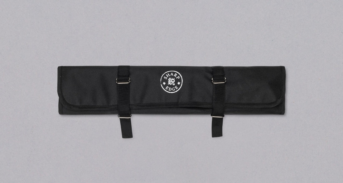 Our SharpEdge Black Chef's Knife Roll is best suited for chefs on-the-go and home cooks who need a small knife roll that can still hold very long knives (up to 440mm (17.3")). It has 4 pockets for knives and utensils, and additional velcro fasteners to keep them in place. A minimalistic, durable black knife bag.