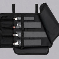 Our SharpEdge Black Chef's Knife Roll is best suited for chefs on-the-go and home cooks who need a small knife roll that can still hold very long knives (up to 440mm (17.3")). It has 4 pockets for knives and utensils, and additional velcro fasteners to keep them in place. A minimalistic, durable black knife bag.