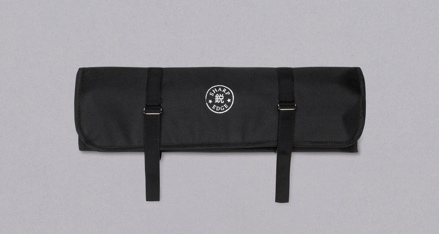 Our SharpEdge Black Chef's Knife Roll is best suited for chefs on-the-go and home cooks who need a sturdy knife roll that can hold very long knives (up to 440mm (17.3")). It has 6 pockets for knives and utensils, and additional velcro fasteners to keep them in place. A minimalistic, durable black knife bag. Get yours.