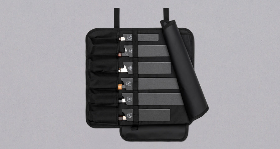 Our SharpEdge Black Chef's Knife Roll is best suited for chefs on-the-go and home cooks who need a sturdy knife roll that can hold very long knives (up to 440mm (17.3")). It has 6 pockets for knives and utensils, and additional velcro fasteners to keep them in place. A minimalistic, durable black knife bag. Get yours.