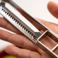 This medium version of the Julienne peeler, SSK-13, from Japanese manufacturer Suncraft is made of very sharp, precise, and thin stainless steel.  A Julienne peeler is a quick and safe tool for making thin julienne strips of vegetables, especially harder veggies like carrots, zucchini, potatoes, sweet potatoes, etc. Great for making garnishes, salad toppings, stir-fries, potato hash browns, citrus zest, and more.  Total length: 190mm (7.5")