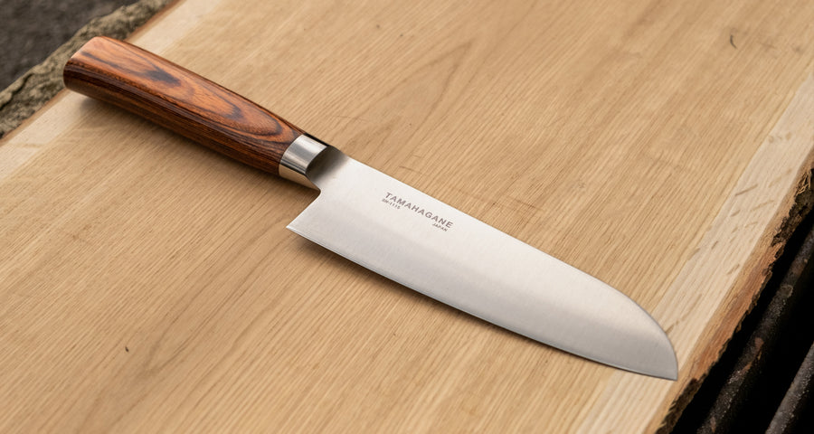 Tamahagane San Santoku in 160mm (6.3") blade length is a universal knife that will excel at a variety of cutting and chopping on a cutting board. A polished blade finish, featured with the core VG-5 steel hardened to 61 HRC.