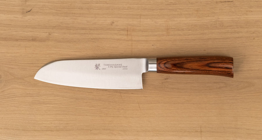 Tamahagane San Santoku in 160mm (6.3") blade length is a universal knife that will excel at a variety of cutting and chopping on a cutting board. A polished blade finish, featured with the core VG-5 steel hardened to 61 HRC.