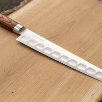 Tamahagane San Sujihiki (or slicer) knife is primarily intended for long pulls and precise cuts of meat and fish. Dimples on the blade also have a practical function: the air in the clefts acts as an anti-stick coating between the knife and the food and reduces the drag during cutting.