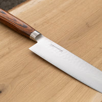 Tamahagane Nakiri is a traditional Japanese knife with a square, thin blade and a deep, flat belly. Perfect knife for cutting vegetables. A matte blade finish, featured with the core VG-5 steel hardened to 61 HRC.