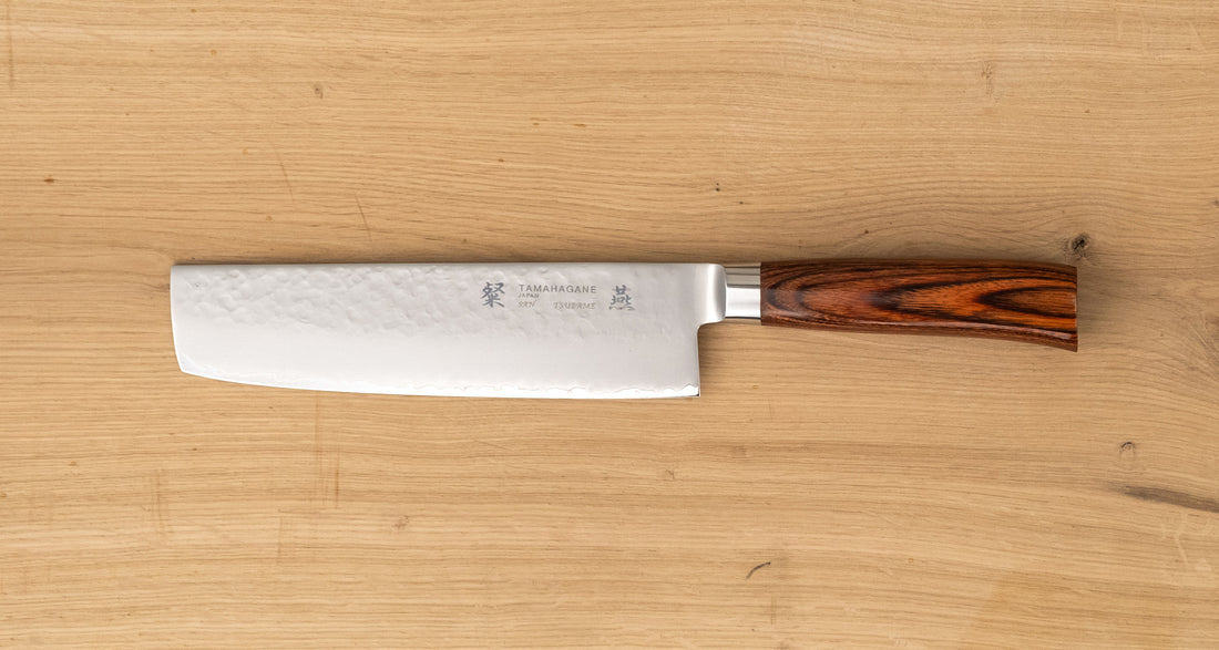 Tamahagane Nakiri is a traditional Japanese knife with a square, thin blade and a deep, flat belly. Perfect knife for cutting vegetables. A matte blade finish, featured with the core VG-5 steel hardened to 61 HRC.