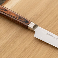 Tamahagane Petty knife is a must-have knife in every kitchen. It can be used for peeling, mincing, paring and decorating food. A matte blade finish, featured with the core VG-5 steel hardened to 61 HRC.