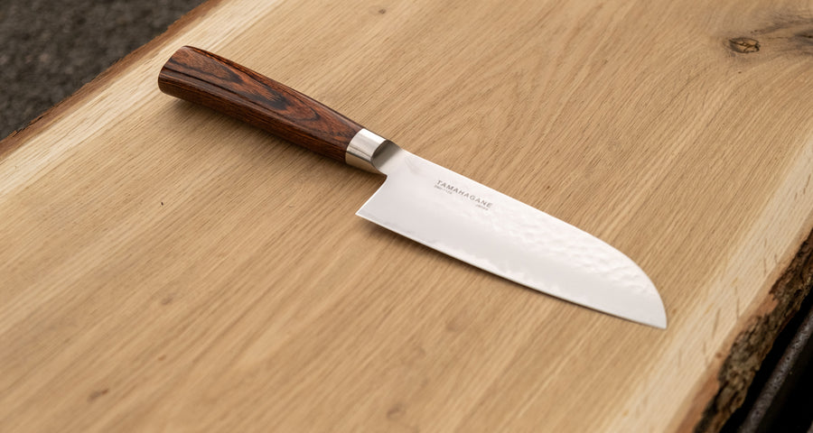 Tamahagane Tsubame Santoku is a universal knife that will excel at a variety of cutting and chopping on a cutting board. With its 120mm (4.7") blade length, it is considered a smaller santoku knife, suitable for those that prefer to work with shorter blades. A matte blade finish, featured with the core VG-5 steel hardened to 61 HRC.