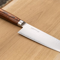 Tamahagane Tsubame Santoku in 175mm (6.9") blade length is a universal knife that will excel at a variety of cutting and chopping on a cutting board. A matte blade finish, featured with the core VG-5 steel hardened to 61 HRC.