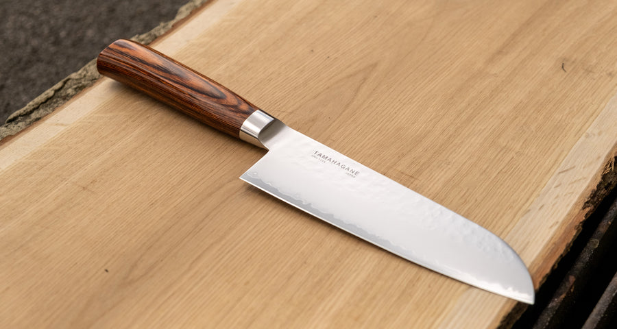 Tamahagane Tsubame Santoku in 175mm (6.9") blade length is a universal knife that will excel at a variety of cutting and chopping on a cutting board. A matte blade finish, featured with the core VG-5 steel hardened to 61 HRC.