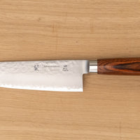 Tamahagane Tsubame Santoku in 175mm (6.9") blade length is a universal knife that will excel at a variety of cutting and chopping on a cutting board. A matte blade finish, featured with the core VG-5 steel hardened to 61 HRC.