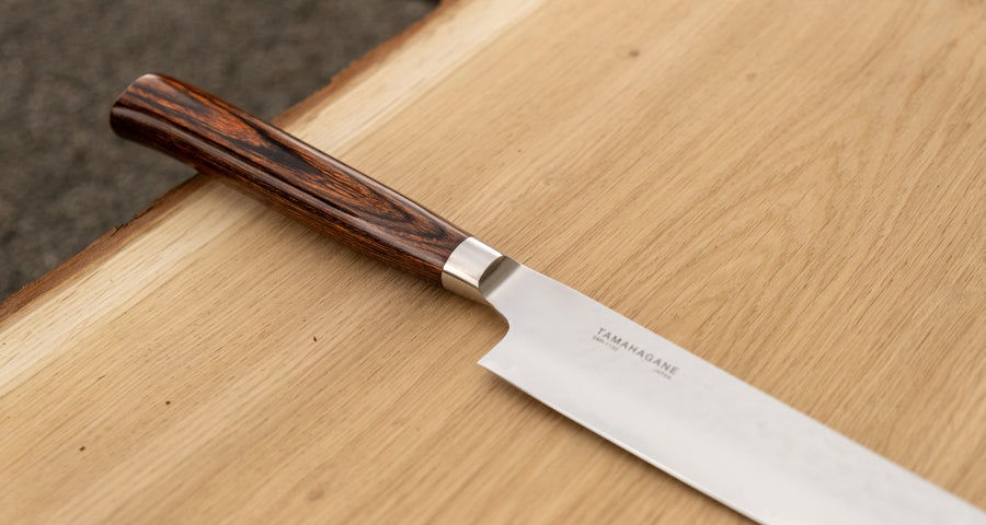 Tamahagane Tsubame Slicer knife is primarily intended for long pulls and precise cuts of meat and fish. The 210mm (8.3") version is the shortest of the slicers, designed for small to medium-sized fish and pieces of meat. A matte blade finish, featured with the core VG-5 steel hardened to 61 HRC.