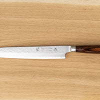 Tamahagane Tsubame Slicer knife is primarily intended for long pulls and precise cuts of meat and fish. The 240mm (9.5") version is designed for medium-sized fish and pieces of meat. A matte blade finish, featured with the core VG-5 steel hardened to 61 HRC.