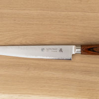 Tamahagane Tsubame Sujihiki (or slicer) knife is primarily intended for long pulls and precise cuts of meat and fish. The 240mm (9.5") version is designed for medium-sized fish and pieces of meat. A matte blade finish, featured with the core VG-5 steel hardened to 61 HRC.